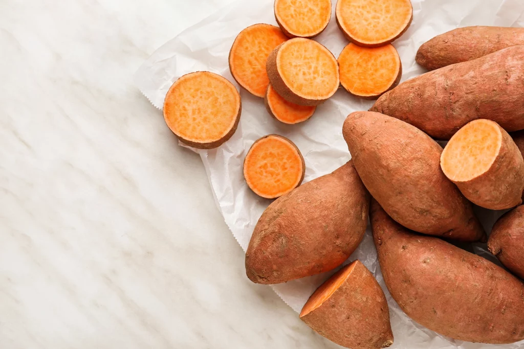 Raw sweet potato on light background - combat chronic inflammation